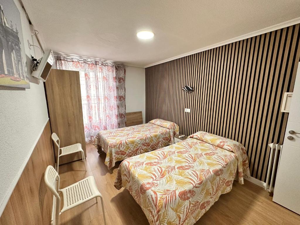 Postel nebo postele na pokoji v ubytování Hostal Rober