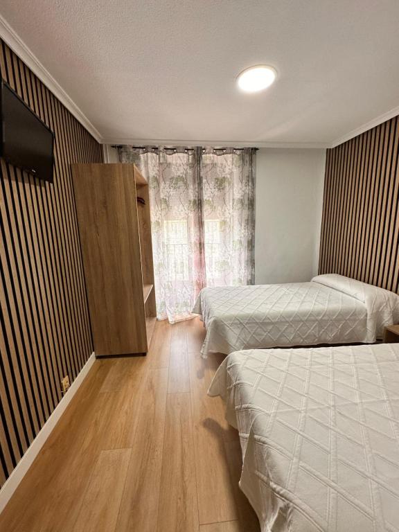 Postel nebo postele na pokoji v ubytování Hostal Rober