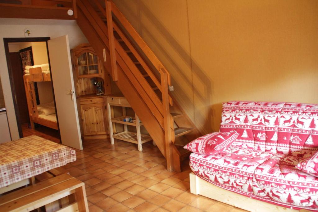 a living room with a couch and a staircase at Alpenlake AP120 VIEW & NATURE 5 pers in Châtel