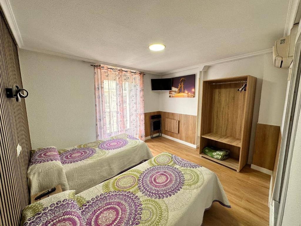 Postel nebo postele na pokoji v ubytování Hostal Rober