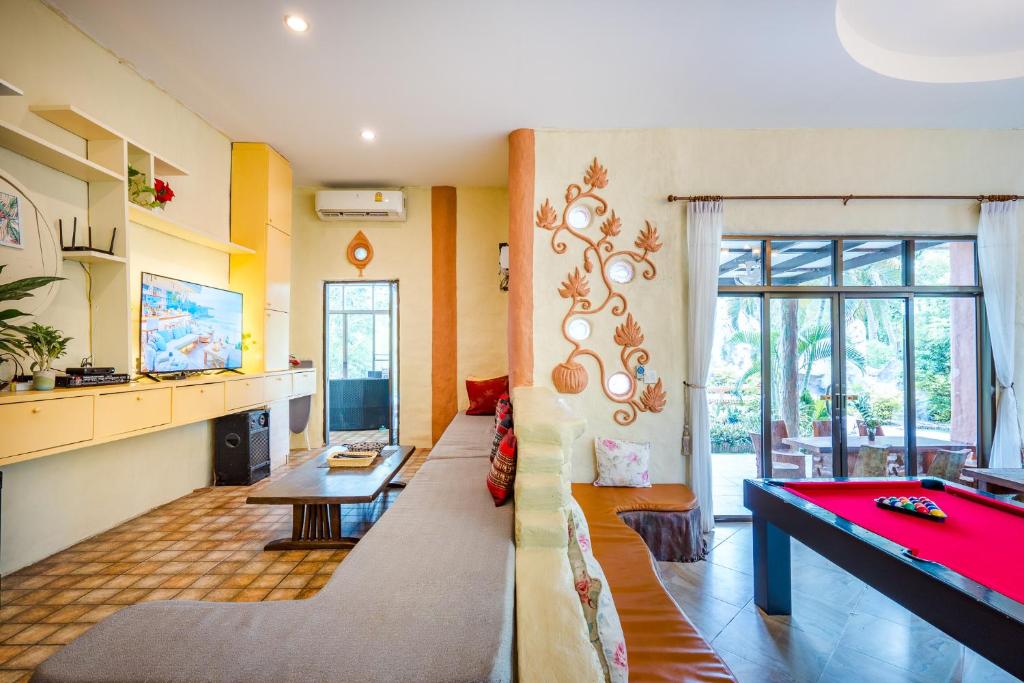 a living room with a couch and a pool table at Huahin I-Din Poolvilla วิลล่ากลางธรรมชาติ วิวภูเขา เป็นส่วนตัว in Hua Hin