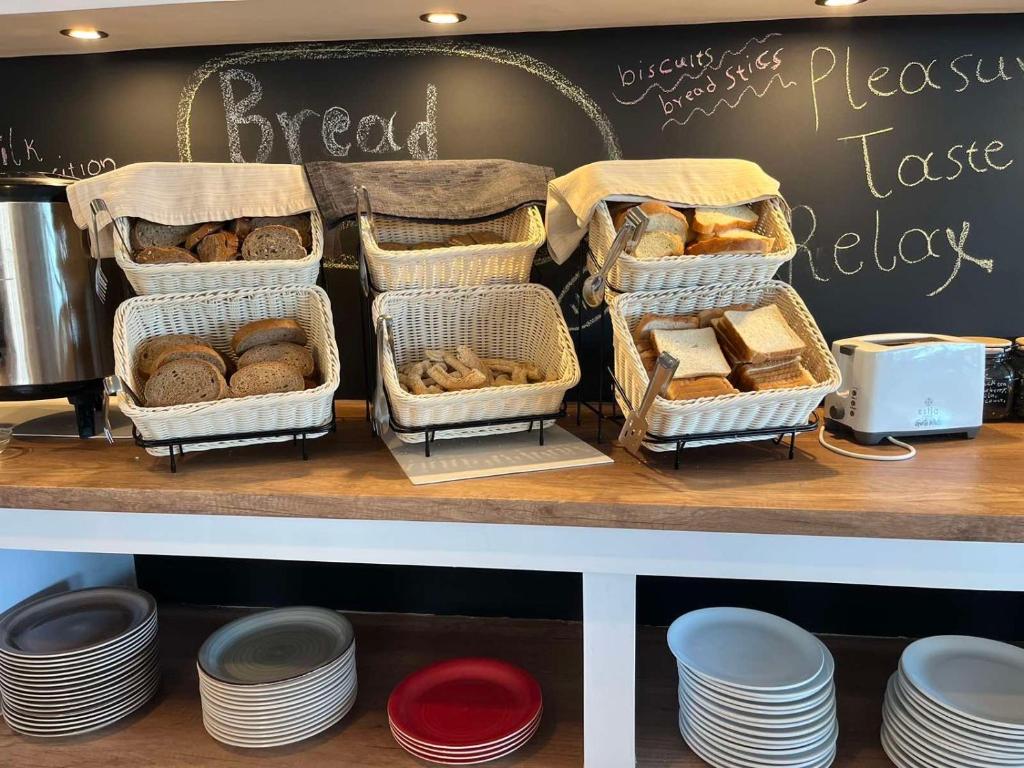 a bakery with baskets of bread on a counter at Skopelos Holidays Hotel & Spa in Skopelos Town