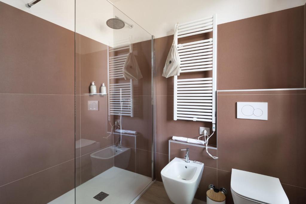 a bathroom with a shower and a toilet and a sink at Villa Il Platano in Como