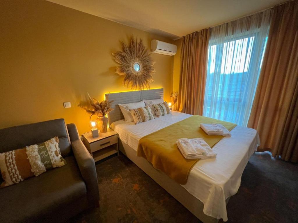 a bedroom with a bed with a chair and a window at Pino - Villa, Casa, Cucina е Terrazza in Albena
