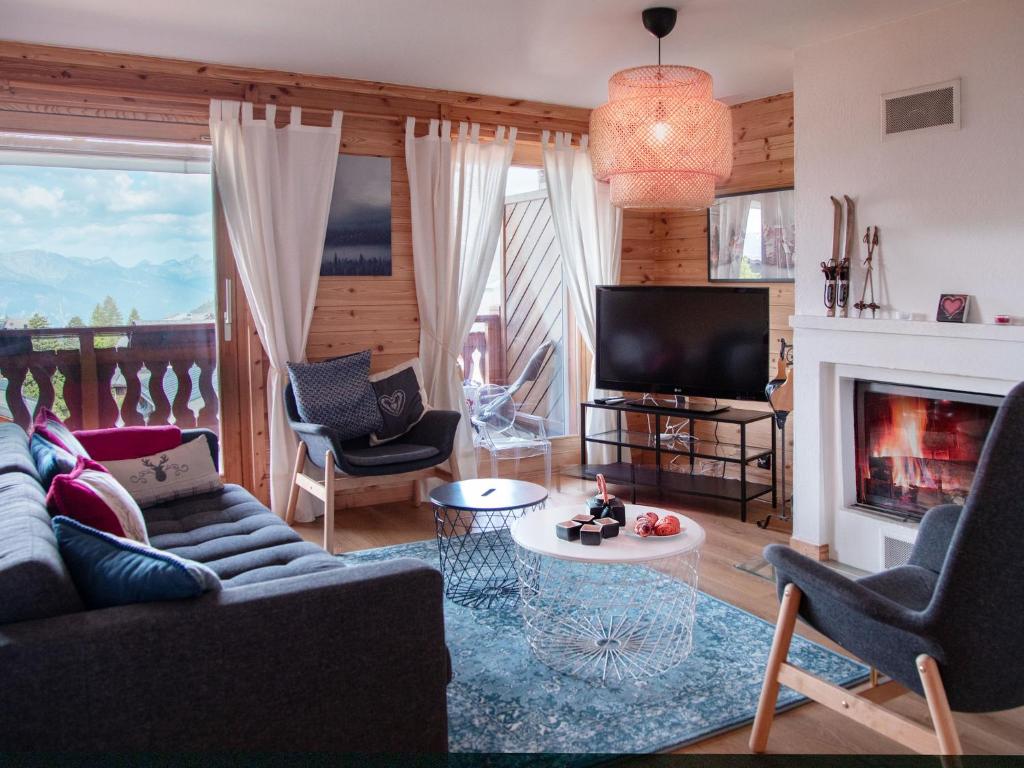 a living room with a couch and a fireplace at Apartment Jade 22 by Interhome in Villars-sur-Ollon