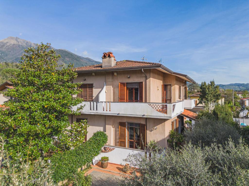 a large house with a tree in front of it at Holiday Home Orchidea by Interhome in Camaiore