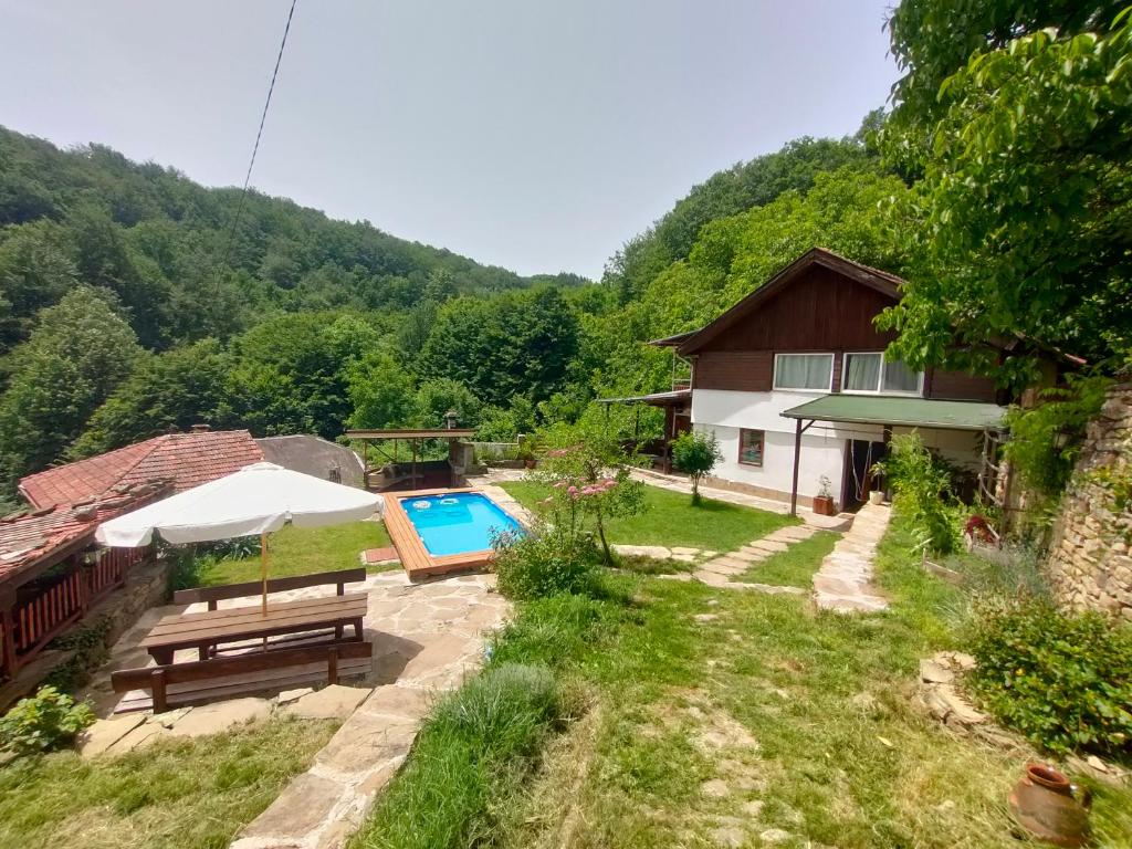 a house with a swimming pool in the yard at Balkans Serendipity - Forest View, Pet friendly Chalet with a garden in Nikolaevo