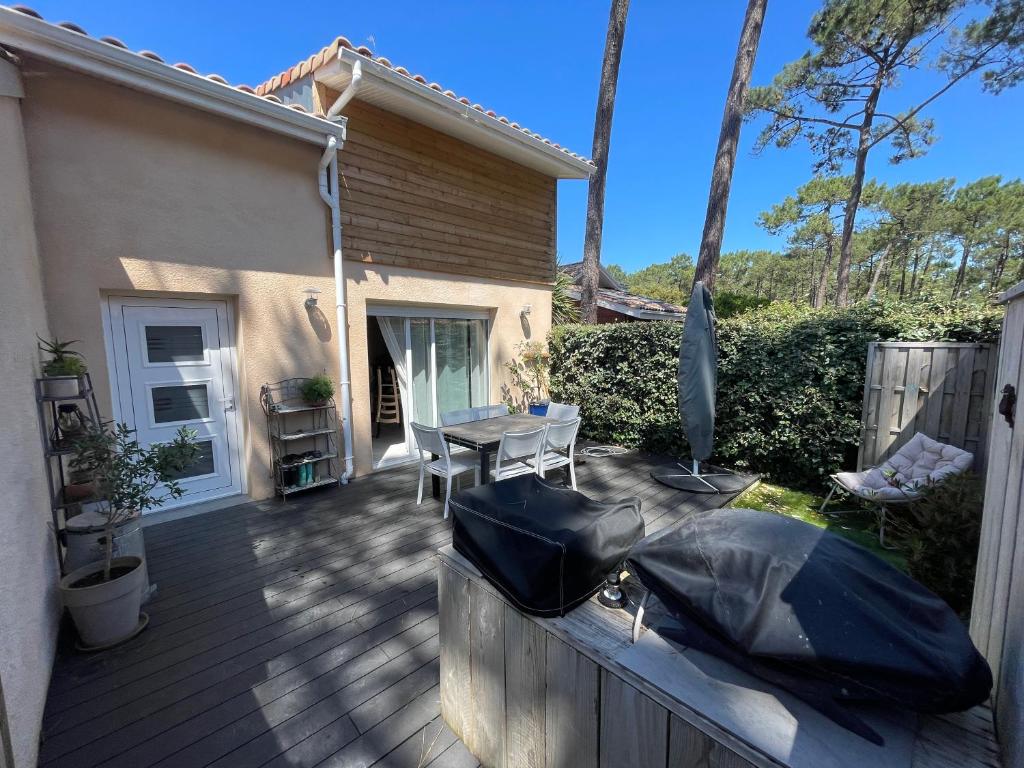 un patio avec une table et des chaises sur une terrasse dans l'établissement Welcome to Lacanau, à Lacanau