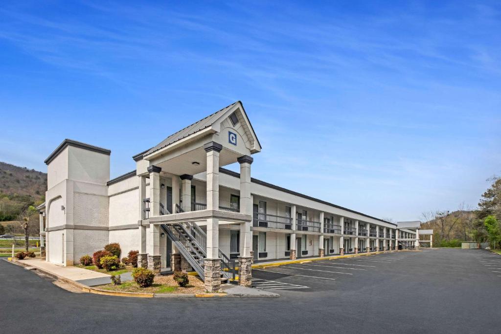 a large white building with a parking lot at Quality Inn in Dalton