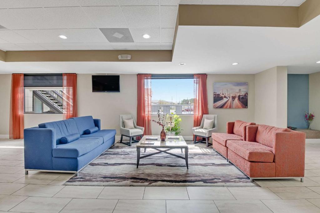 a living room with two couches and a table at Quality Inn in Dalton