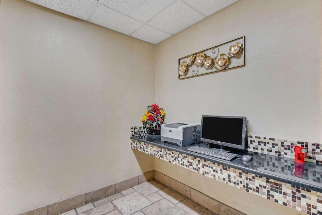 a computer on a counter in a waiting room at Quality Inn in Dalton