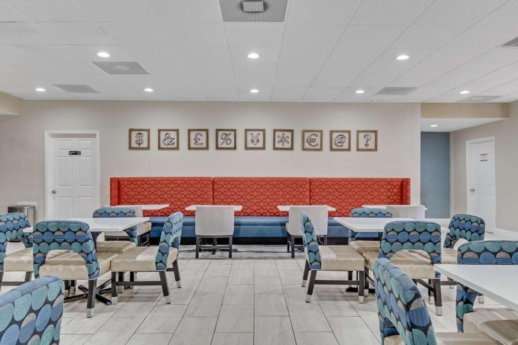 a waiting room with tables and chairs at Quality Inn in Dalton