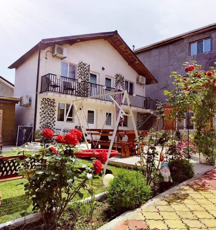 a house with a garden in front of it at Casa Georgeta 2 Mai-Punct Gastronomic Local-AROME DOBROGENE in 2 Mai