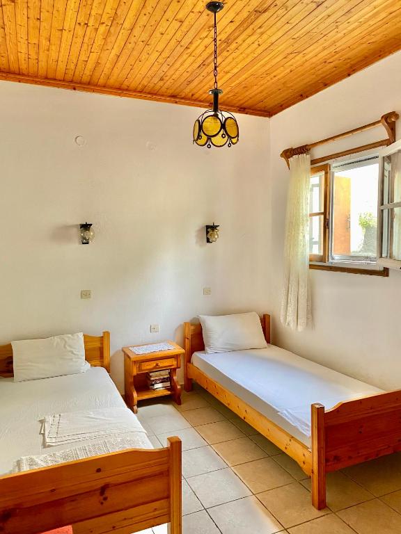 a bedroom with two beds and a window at Betsanis Stafylos Apartments in Stafylos