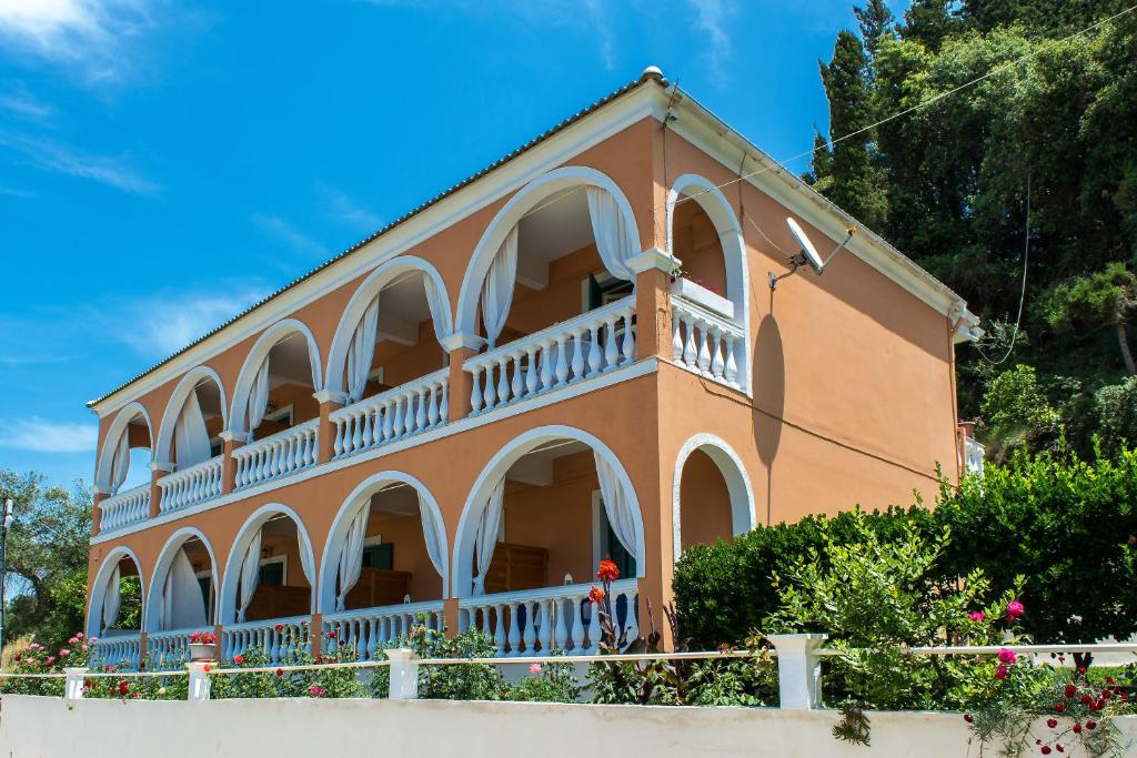 a building with arched windows and a balcony at Angeliki in Vitalades