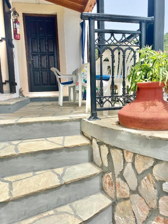 a set of stairs leading to a front door at Betsanis Stafylos Apartments in Stafylos