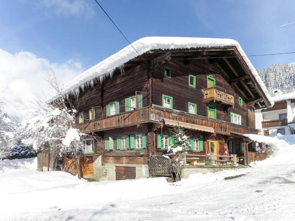 a large wooden house with snow on the roof at Holiday Home Geislerhütte by Interhome in Ramsau