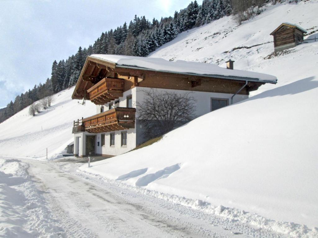 a building on a snow covered hill with a road at Apartment Prieslern-2 by Interhome in Dorf