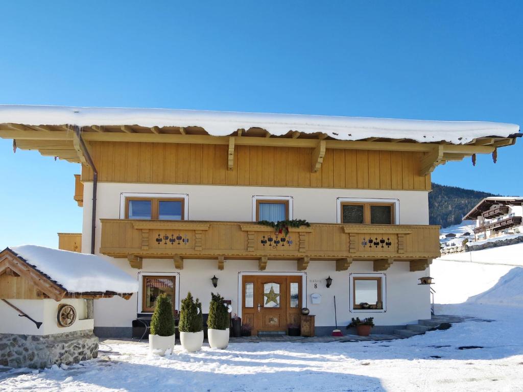a house in the snow with a balcony at Apartment Schoppengrub by Interhome in Mühlbach