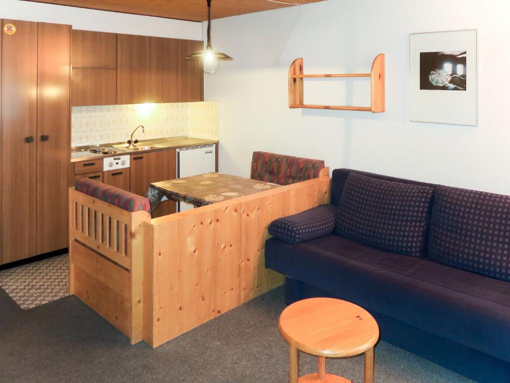 a living room with a couch and a kitchen at Studio Résidence Dixence-3 by Interhome in Les Collons