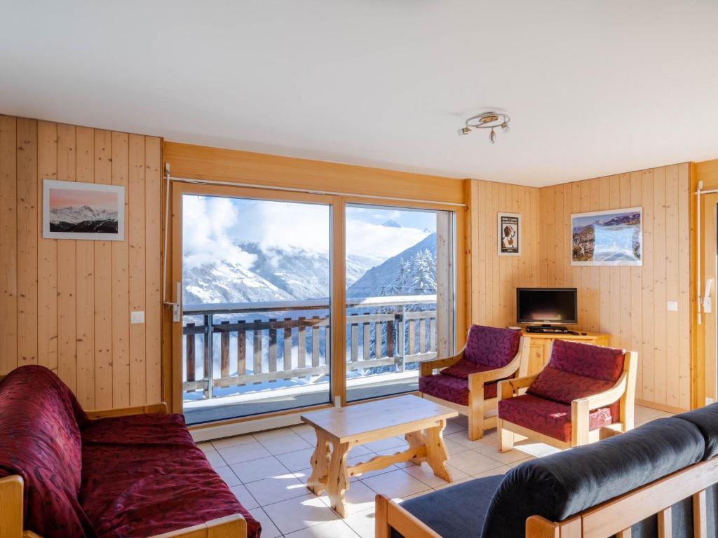 a living room with a view of a mountain at Apartment Les Cîmes 4 by Interhome in Les Collons