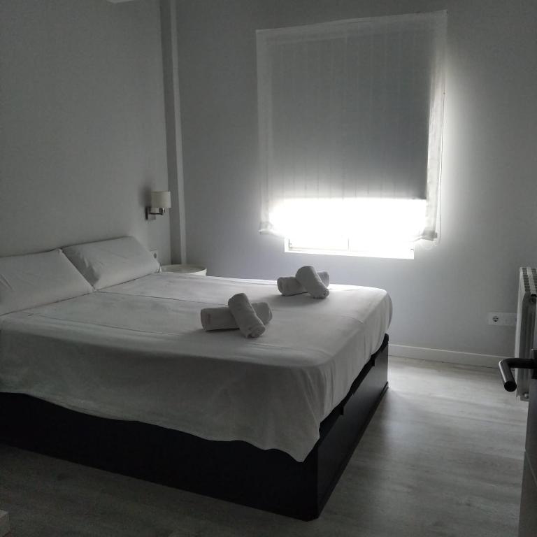 Posteľ alebo postele v izbe v ubytovaní Nuevo! Piso en pleno centro