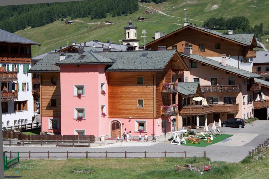 a group of buildings in a town with a church at Bio Hotel Villa Cecilia in Livigno