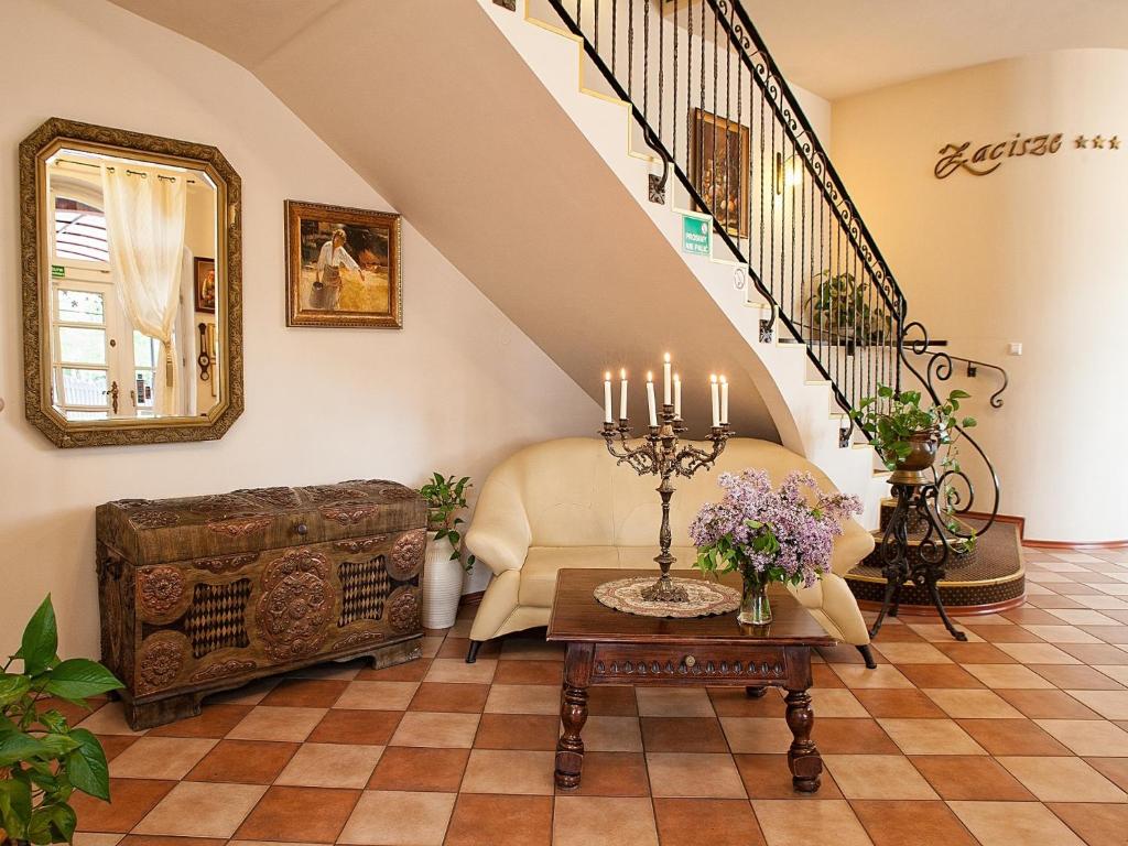 a living room with a couch and a table at Pensjonat Zacisze in Plewiska