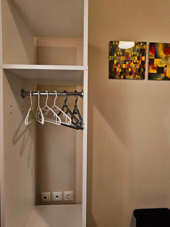 a room with a closet with hangers and a painting at VMA Residence in Artemida