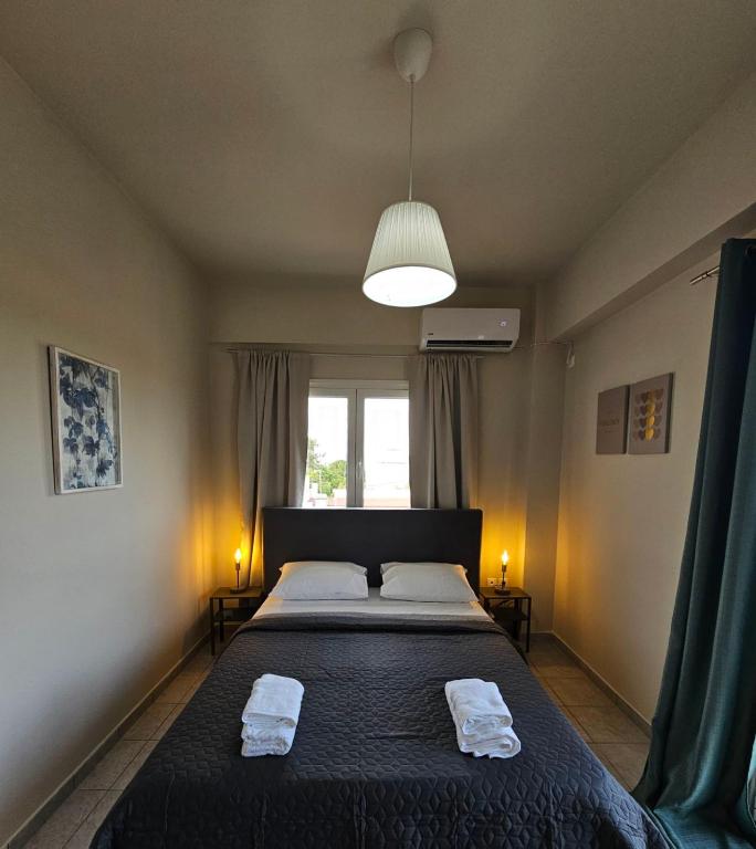 a bedroom with a bed with two towels on it at VMA Residence in Artemida