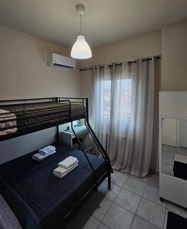 a bedroom with two bunk beds and a window at VMA Residence in Artemida