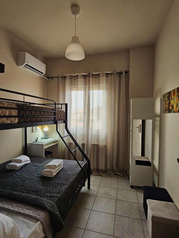 a bedroom with a bunk bed and a desk at VMA Residence in Artemida