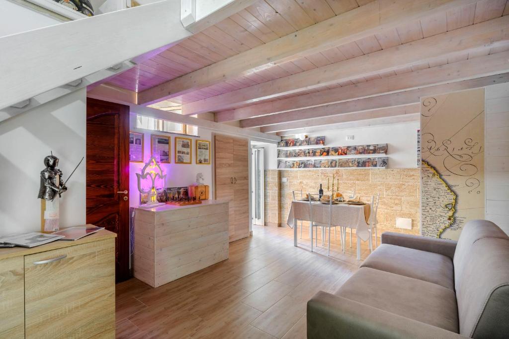 a living room with a couch and a dining room at La Dimora Del Duca Nel Salento in Taurisano