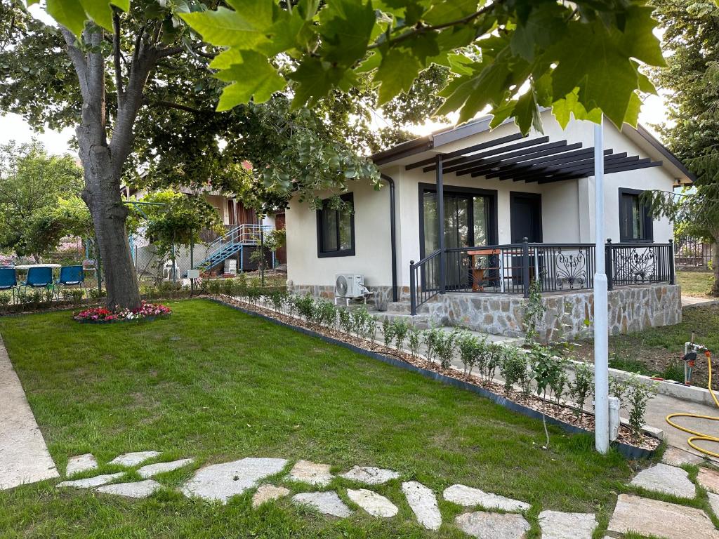a house with a tree in the yard at Villa Sea House in Byala