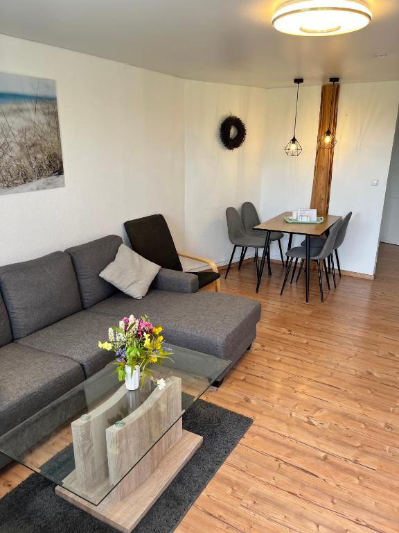 a living room with a couch and a table at Ferienwohnung Nr 4 in Hinrichsdorf