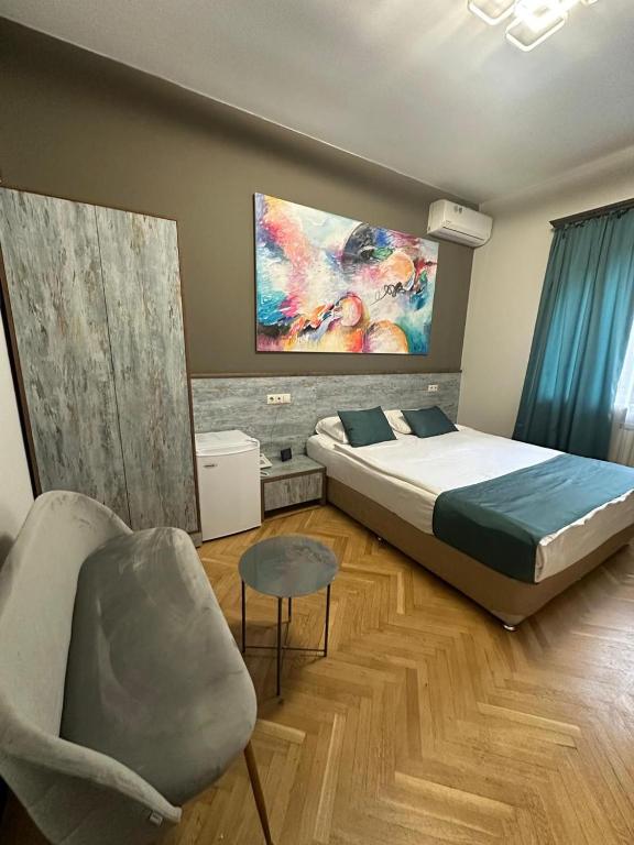 a bedroom with a bed and a couch and a chair at Yerevan Boutique Hotel in Yerevan