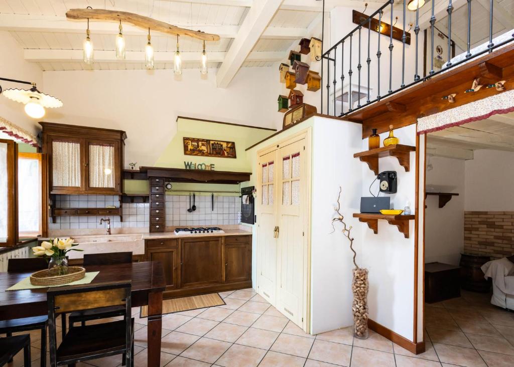 a kitchen with a table and a dining room at Luminosa Mansarda nel Cuore di Intra in Intra