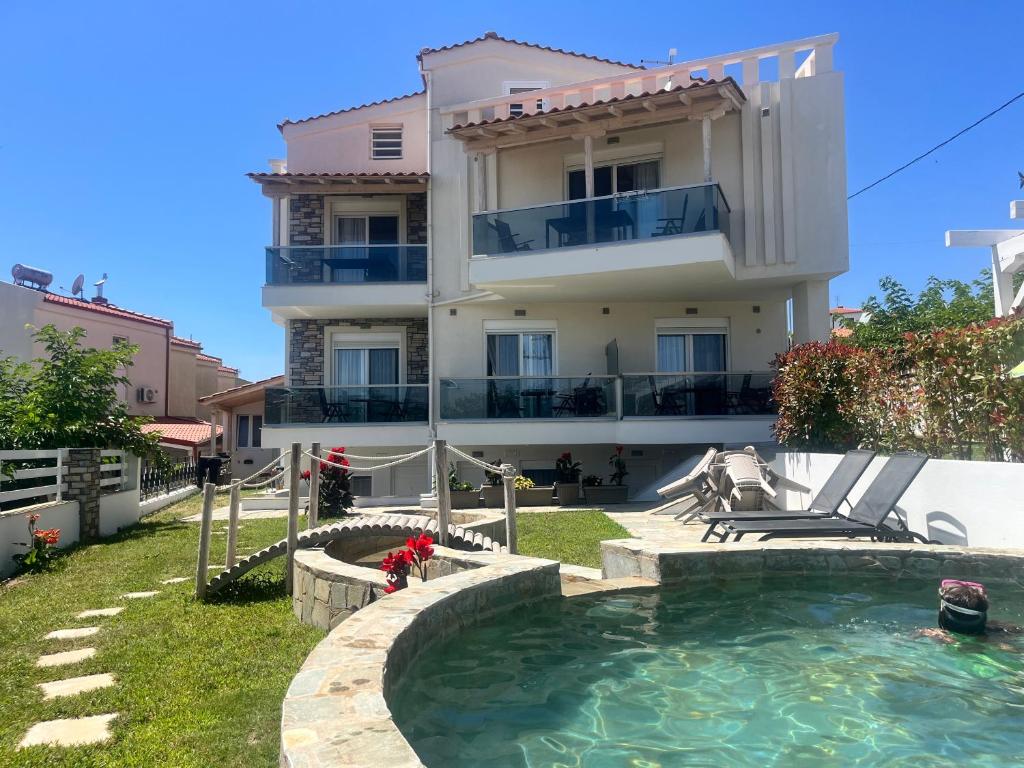 a house with a swimming pool in front of it at Villa Nikiti View in Nikiti