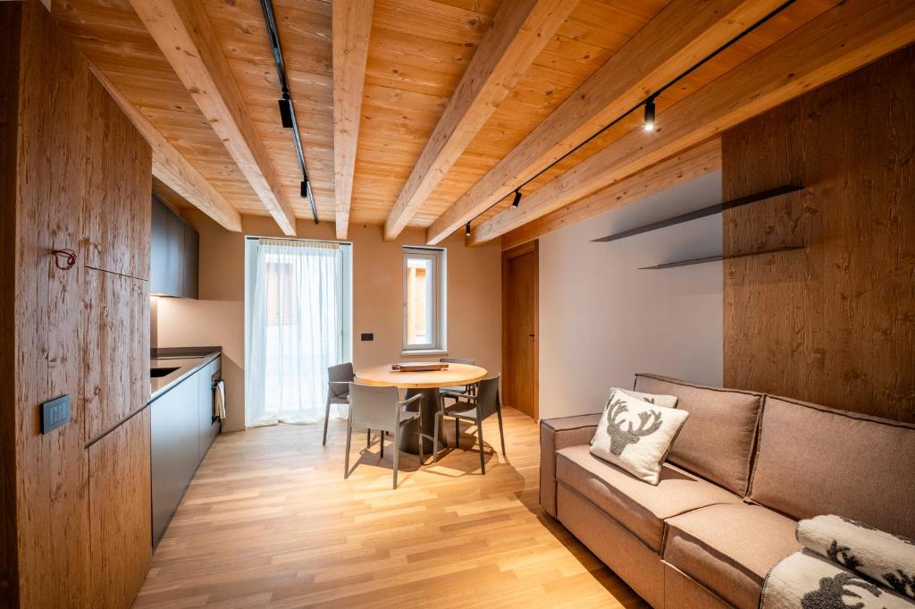 a living room with a couch and a table at DALANIA MOUNTAIN APARTMENTS in Ponte di Legno