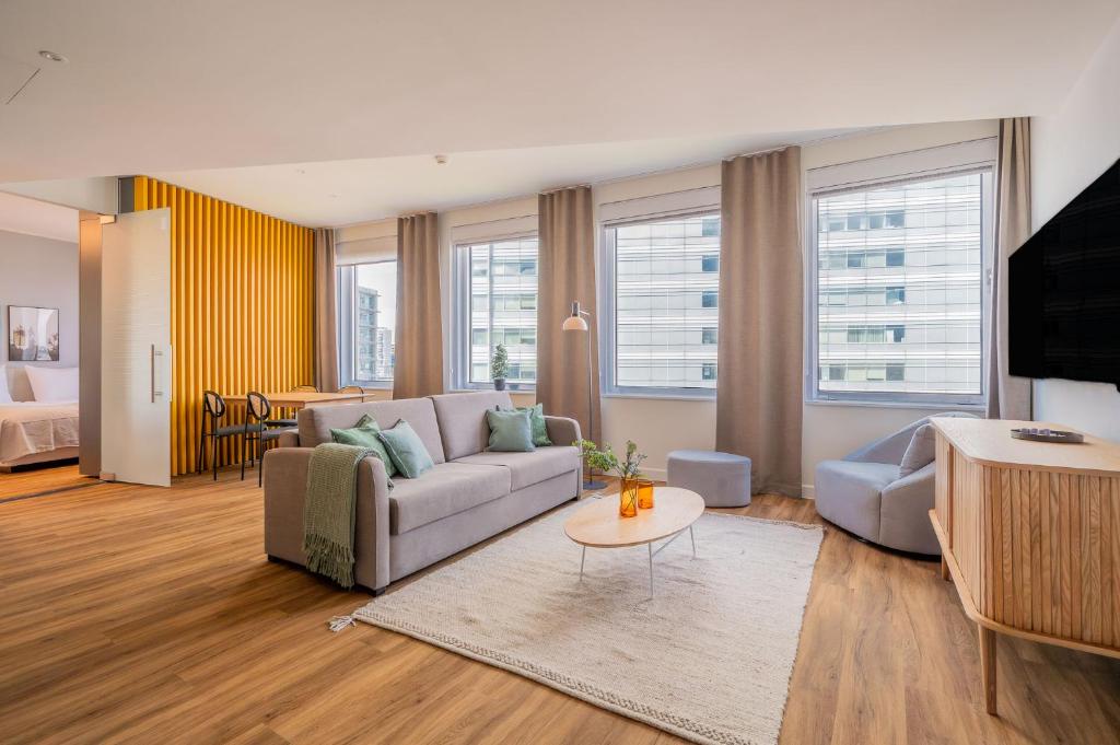 a living room with a couch and a table at Limehome Amsterdam Gatwickstraat in Amsterdam