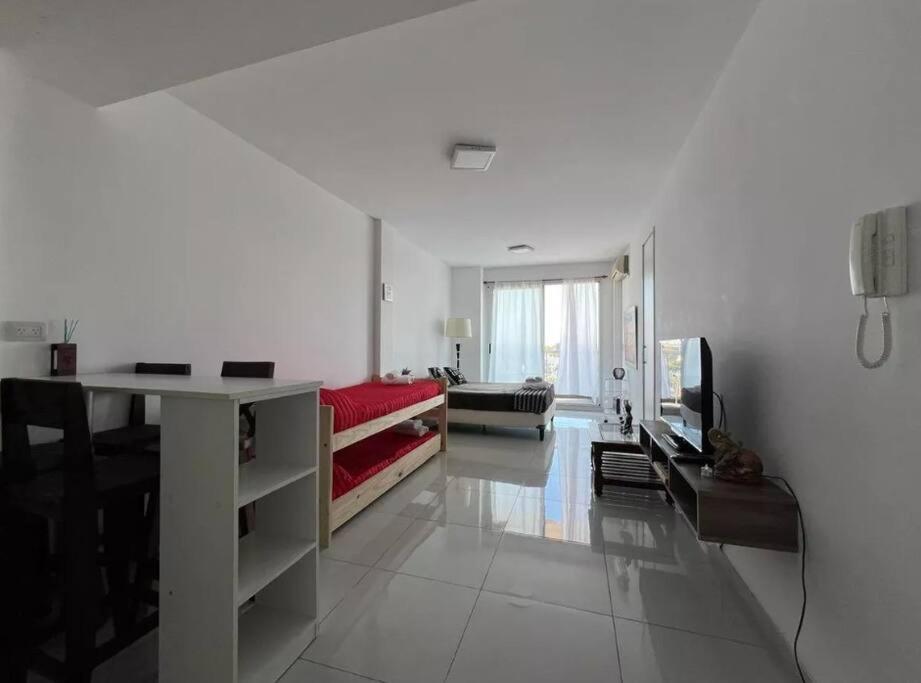 a white living room with a couch and a table at Hermoso 1amb Lindo SuperCompleto in Buenos Aires