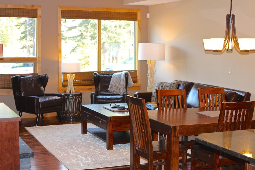 a living room with a table and chairs at Luxury Canmore Vacations in Canmore