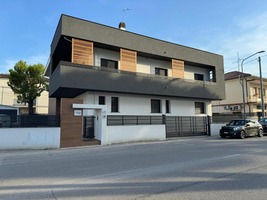 a building with a car parked in front of it at B&B Room47 in Alba Adriatica