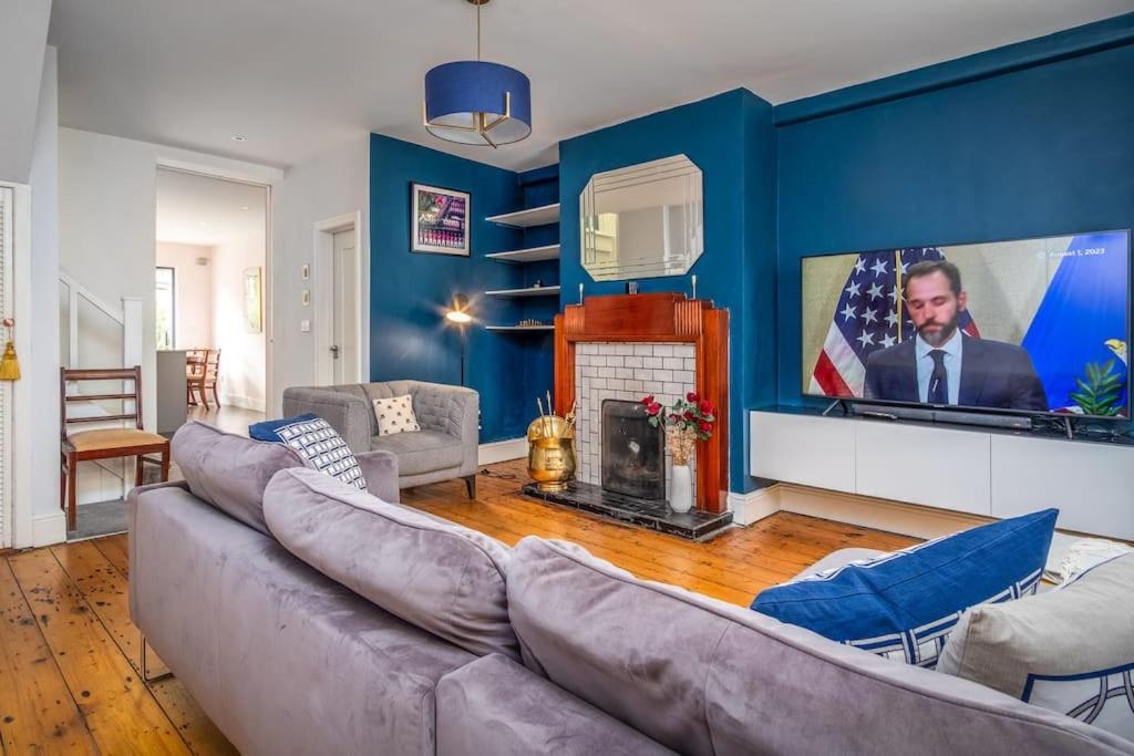 a living room with a large couch and a tv at The Chancery in Dublin
