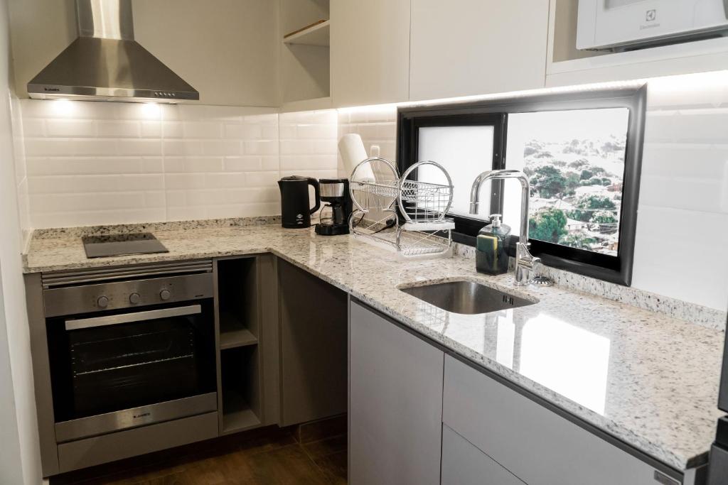una cocina con fregadero y estufa en Excelente Depto en Las Lomas, en Asunción