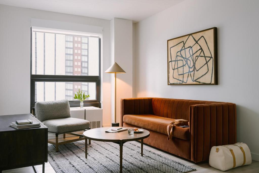a living room with a couch and a chair at Sonder Court Square in Long Island City