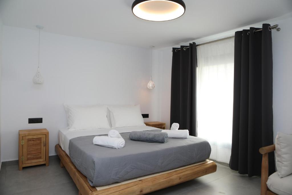 a bedroom with a bed with two towels on it at White Dream Suites Antiparos in Antiparos