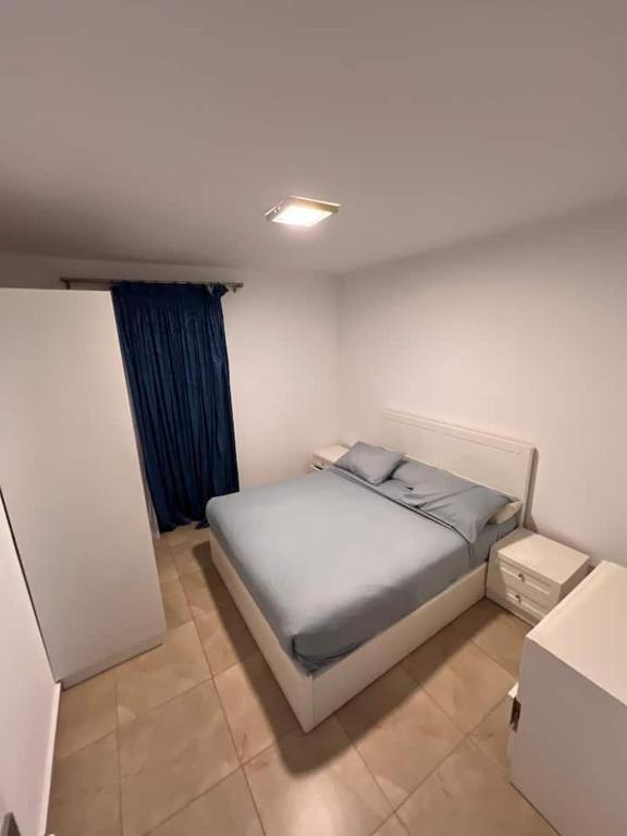 a small bedroom with a bed and a window at Serene Selena Bay Apartments in Hurghada