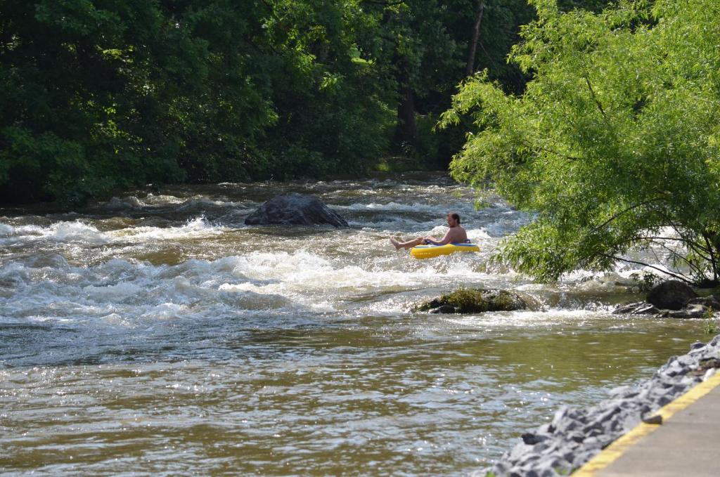 a person riding a raft in a river at Creekstone Inn in Pigeon Forge
