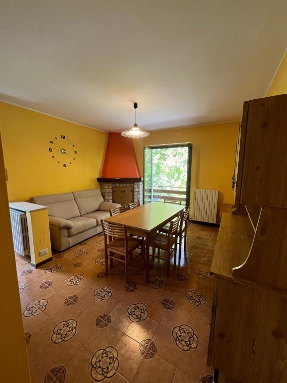 a living room with a table and a couch at Casa alla Rocca in Clusone